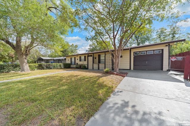 ranch-style home with a garage and a front lawn