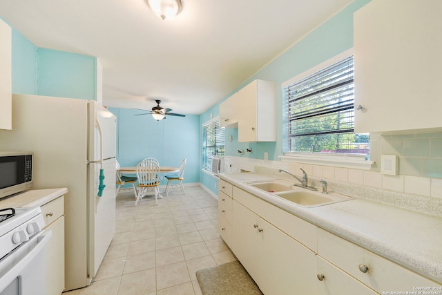 kitchen featuring white range, sink, ceiling fan, light tile patterned floors, and tasteful backsplash