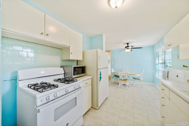 kitchen featuring white cabinets, light tile patterned floors, white appliances, and tasteful backsplash