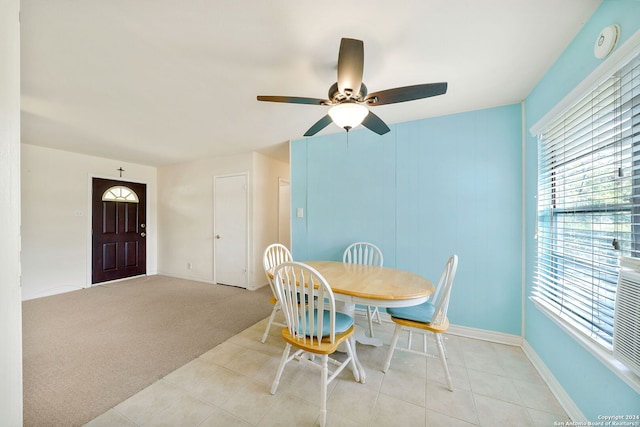 dining area featuring ceiling fan and light colored carpet