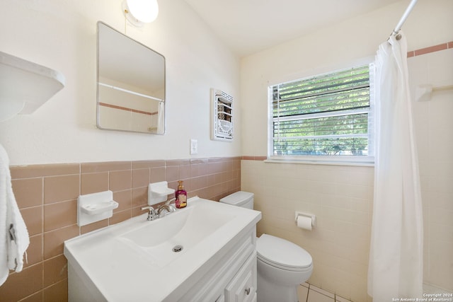 bathroom featuring a shower with curtain, vanity, toilet, and tile walls