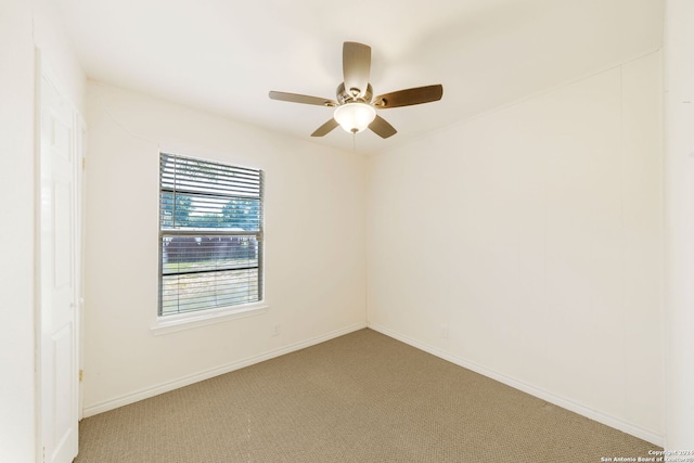 spare room featuring ceiling fan and carpet