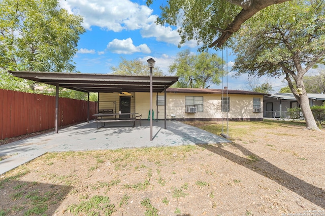 back of property featuring a carport