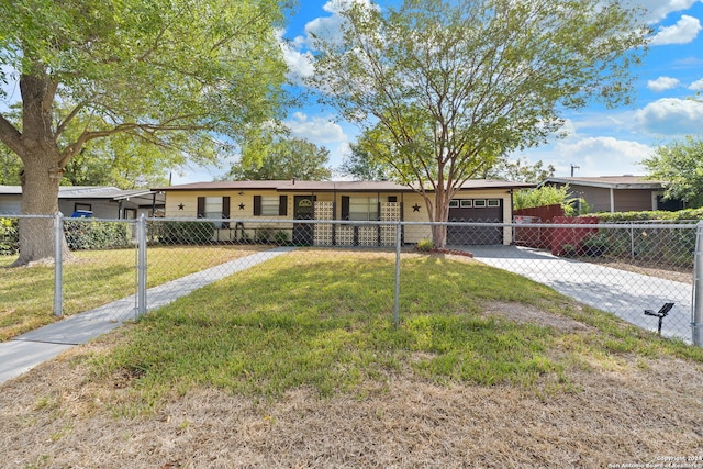 single story home with a front yard and a garage