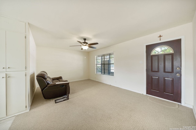 entryway with plenty of natural light, ceiling fan, and light colored carpet