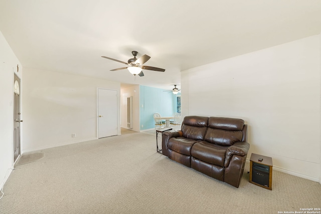 carpeted living room featuring ceiling fan