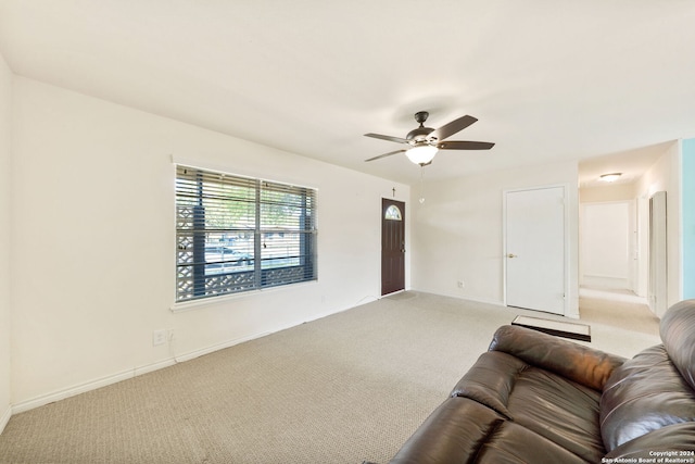 carpeted living room featuring ceiling fan