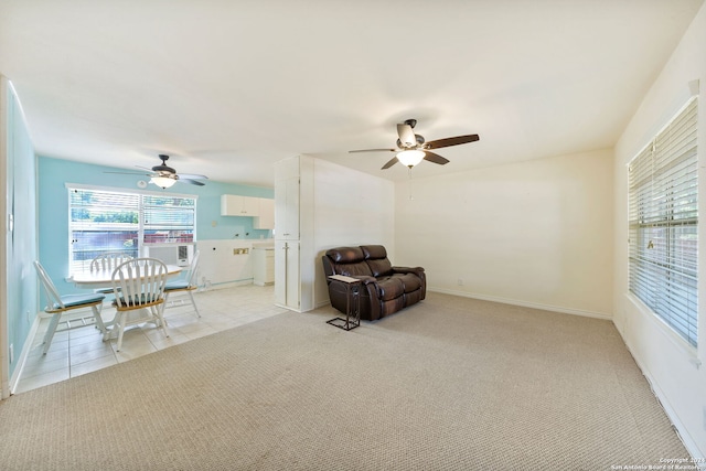 sitting room with ceiling fan and light carpet