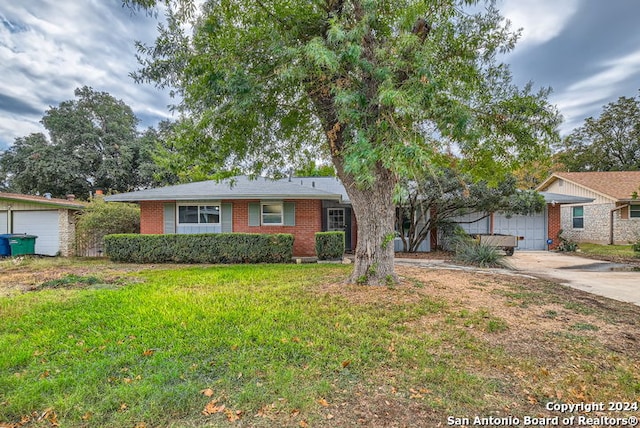 ranch-style home with a garage and a front lawn