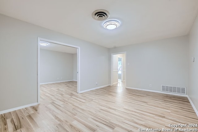 empty room with light hardwood / wood-style flooring