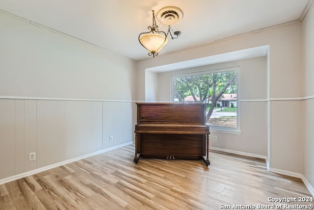 misc room with light wood-type flooring and ornamental molding