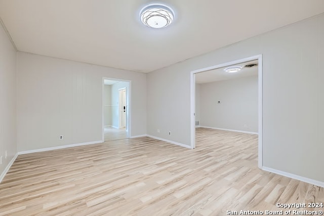 empty room with light hardwood / wood-style flooring