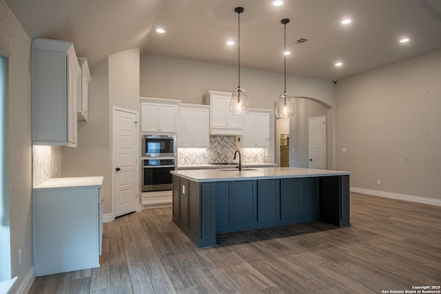 9104 Pepperton Ln, San Antonio, TX 78254 - kitchen with appliances with stainless steel finishes, white cabinetry, a center island with sink, backsplash, and light countertops