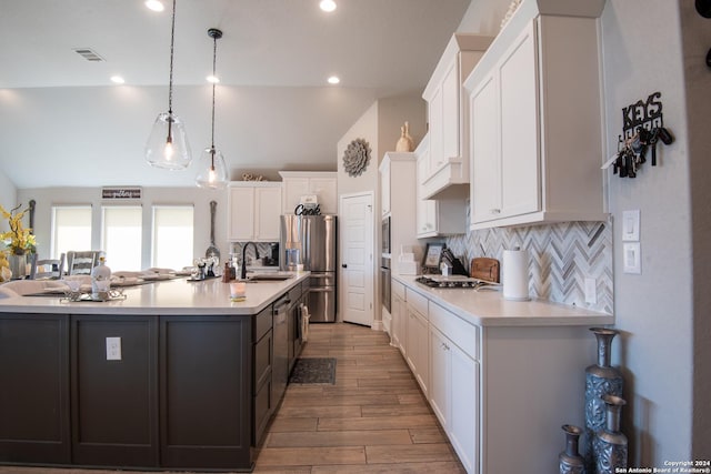 9104 Pepperton Ln, San Antonio, TX 78254 - kitchen featuring appliances with stainless steel finishes, white cabinets, light countertops, recessed lighting, and lofted ceiling
