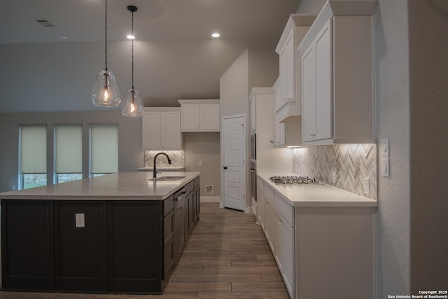 9104 Pepperton Ln, San Antonio, TX 78254 - kitchen with a sink, backsplash, wood finished floors, light countertops, and white cabinets