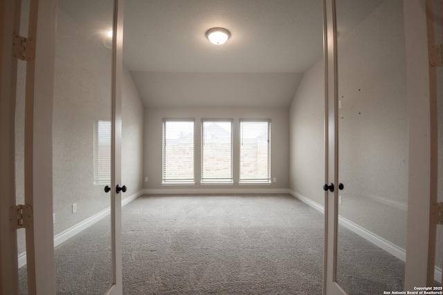9104 Pepperton Ln, San Antonio, TX 78254 - spare room with french doors, carpet floors, vaulted ceiling, and baseboards