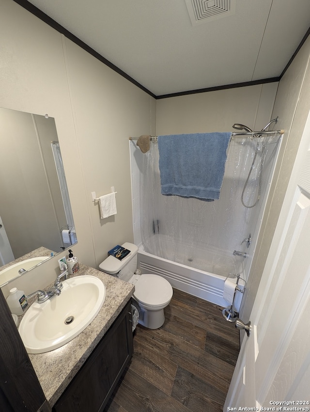 full bathroom with hardwood / wood-style floors, vanity, toilet, and shower / bathtub combination with curtain