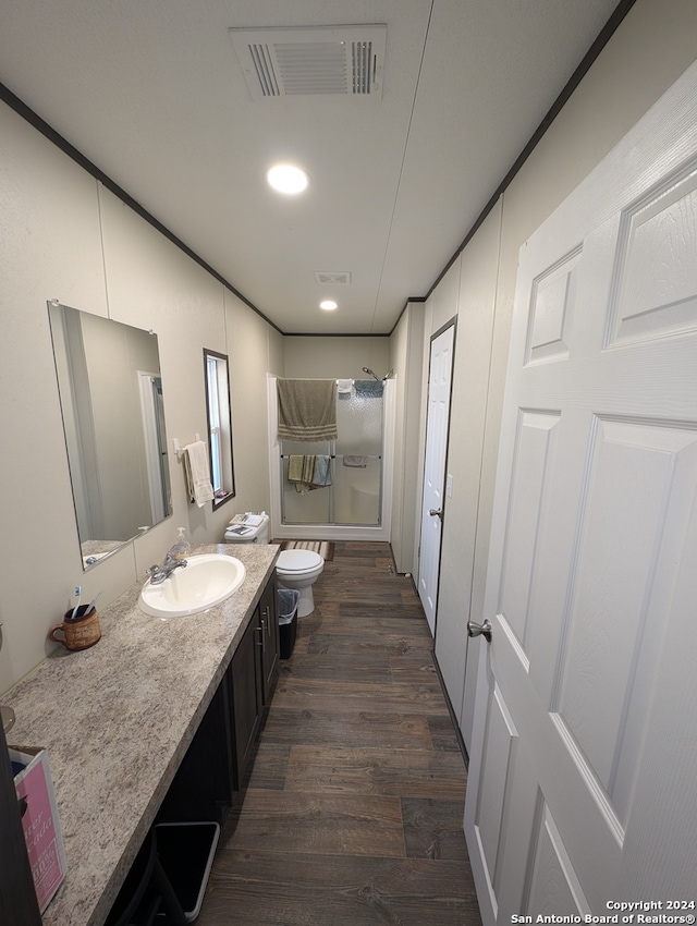 full bathroom featuring toilet, hardwood / wood-style floors, vanity, and bathing tub / shower combination