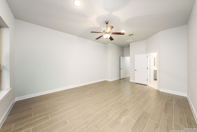 empty room featuring ceiling fan and light wood-type flooring