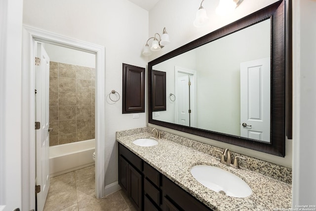 full bathroom featuring tile patterned flooring, vanity, toilet, and tiled shower / bath