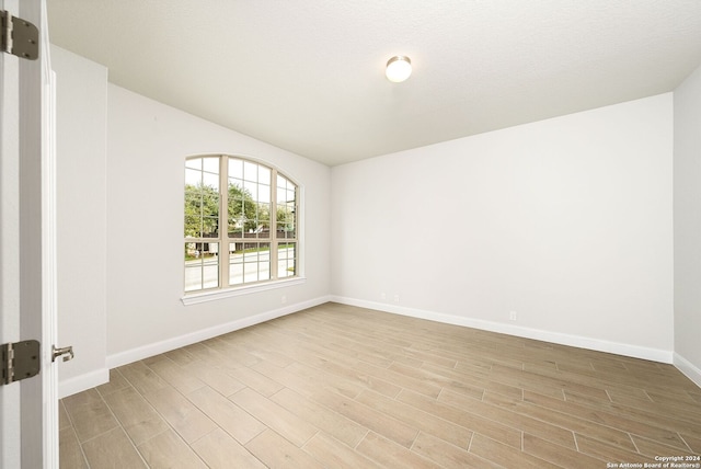 unfurnished room with light hardwood / wood-style flooring