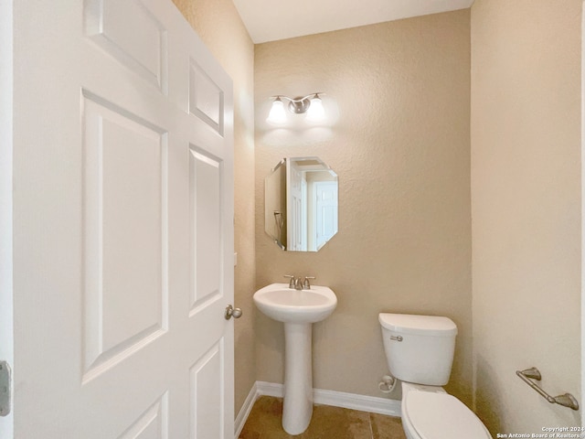 bathroom with sink, tile patterned flooring, and toilet