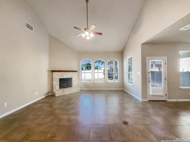 unfurnished living room with tile patterned floors, high vaulted ceiling, and ceiling fan