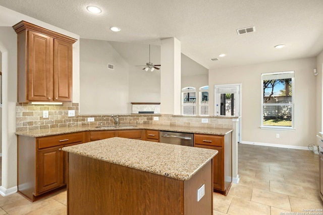 9615 Calmont Way, San Antonio, TX 78251 - kitchen featuring stainless steel dishwasher, a sink, a center island, a ceiling fan, and light stone counters
