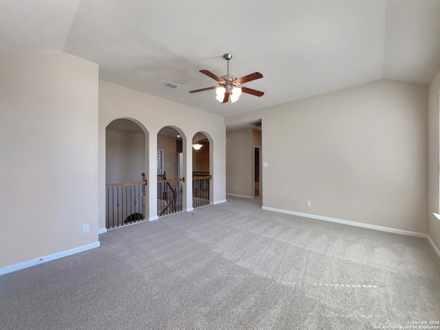 spare room with carpet flooring, ceiling fan, and vaulted ceiling