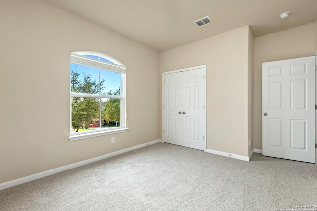 unfurnished bedroom featuring a closet and carpet