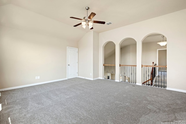 spare room with carpet, vaulted ceiling, and ceiling fan