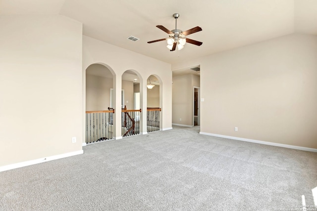 carpeted spare room featuring ceiling fan and lofted ceiling