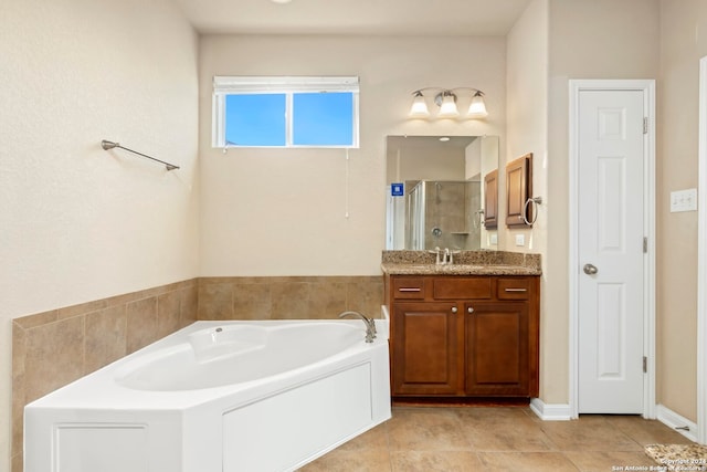 bathroom with tile patterned flooring, vanity, and plus walk in shower