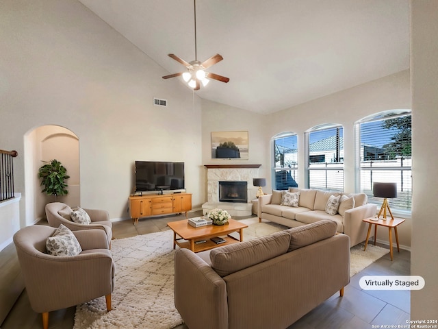 9615 Calmont Way, San Antonio, TX 78251 - tiled living area featuring a ceiling fan, a tiled fireplace, baseboards, and high vaulted ceiling