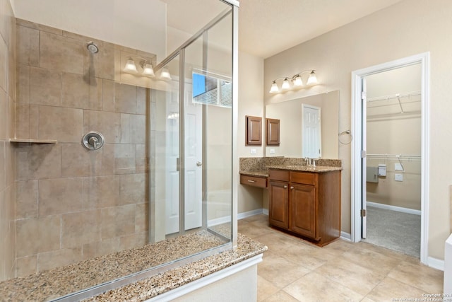 bathroom featuring tile patterned floors, vanity, and an enclosed shower