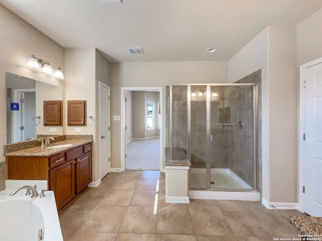 bathroom featuring vanity, tile patterned flooring, and plus walk in shower