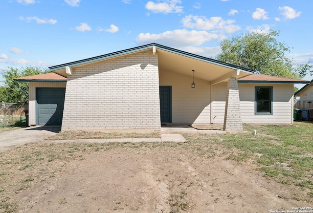 rear view of house featuring a garage