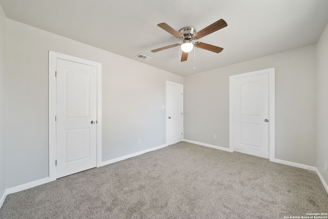 carpeted empty room with ceiling fan