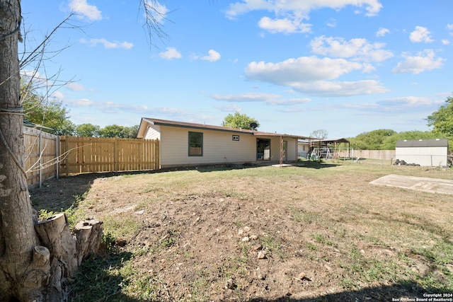 rear view of property featuring a yard