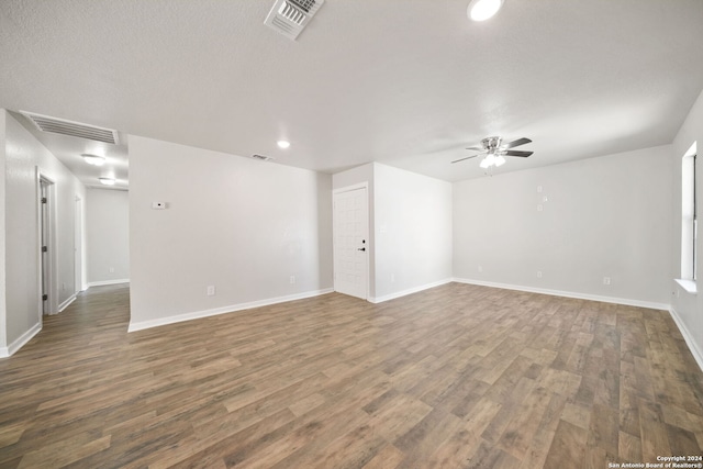 unfurnished room with ceiling fan and dark hardwood / wood-style flooring