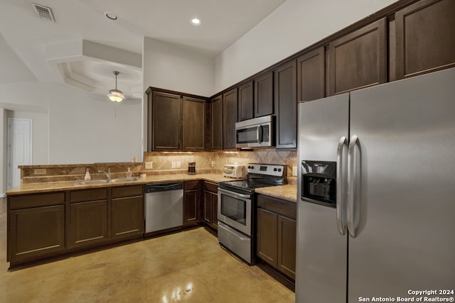 kitchen with backsplash, dark brown cabinetry, sink, and stainless steel appliances