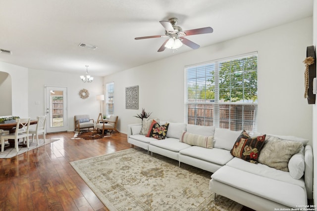 living room with dark hardwood / wood-style floors and ceiling fan with notable chandelier