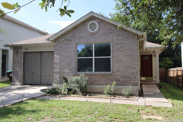 view of front of house with a garage and a front lawn