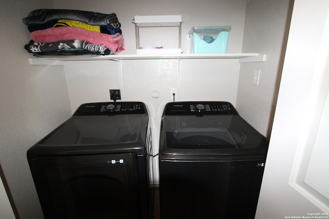 clothes washing area with washing machine and clothes dryer