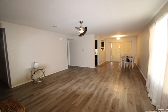 unfurnished living room featuring dark wood-type flooring