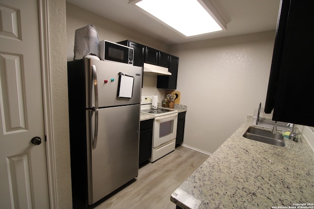 kitchen with sink, light hardwood / wood-style flooring, stainless steel fridge, light stone countertops, and white range with electric stovetop