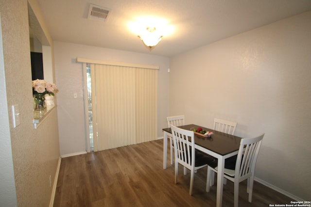 dining space with dark wood-type flooring