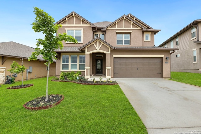 view of front of house featuring a front yard and a garage