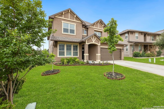 view of front of property featuring a garage and a front lawn