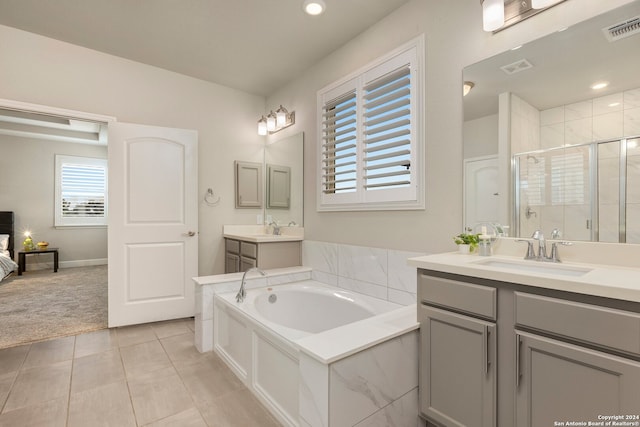 bathroom with shower with separate bathtub, vanity, and tile patterned floors